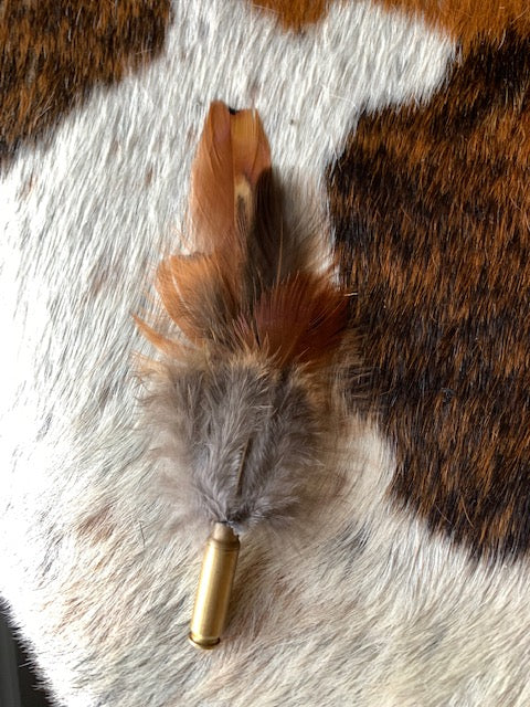 Feather cluster in empty bullet casing